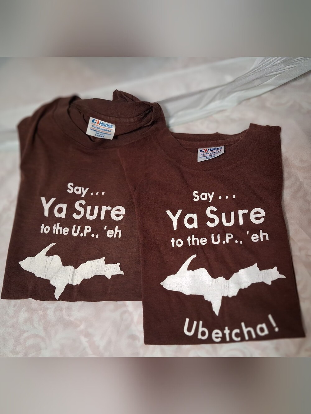 Two adult Michigan Upper Peninsula T-shirts printed with iconic phrase. Lrg&Sm